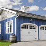 A blue and white garage with two doors.