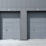 Two grey doors in a building with the door open.
